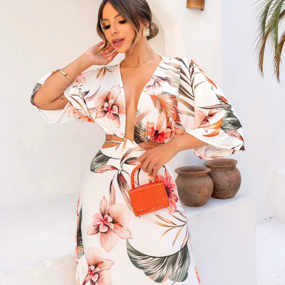 Woman wearing pink and green floral beach maxi dress from J and E Luxe Boutique